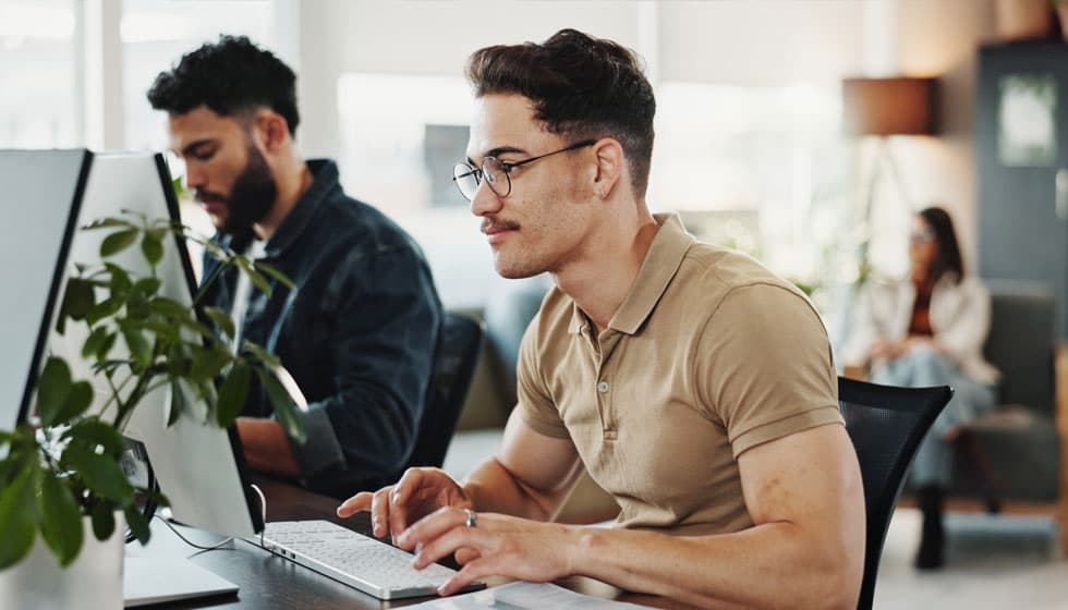 Man using paperless onboarding solutions inside different HR platforms.